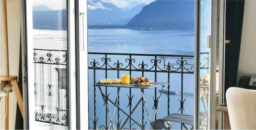 Breakfast on a lake-view balcony of Le Baron Tavernier