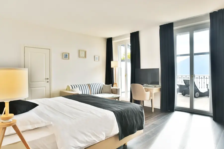 Junior Lake Suite — bed and lake-view terrace