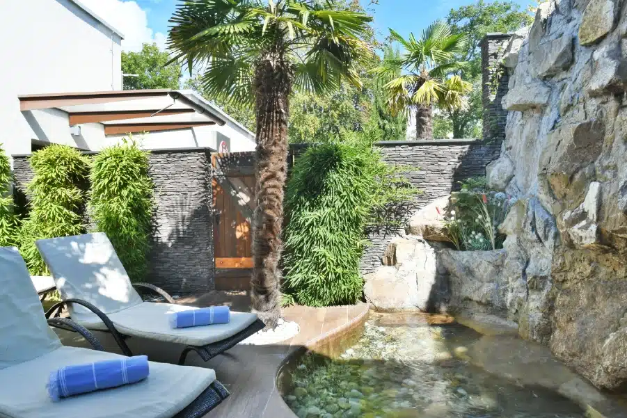 The zen garden of Clinique Eden Spa with sun loungers