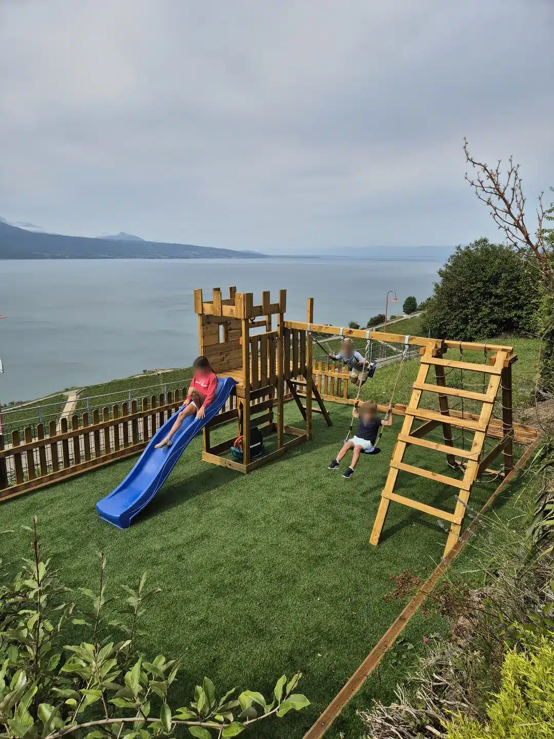 Children playing at the Baron Tavernier playground above Lake Geneva